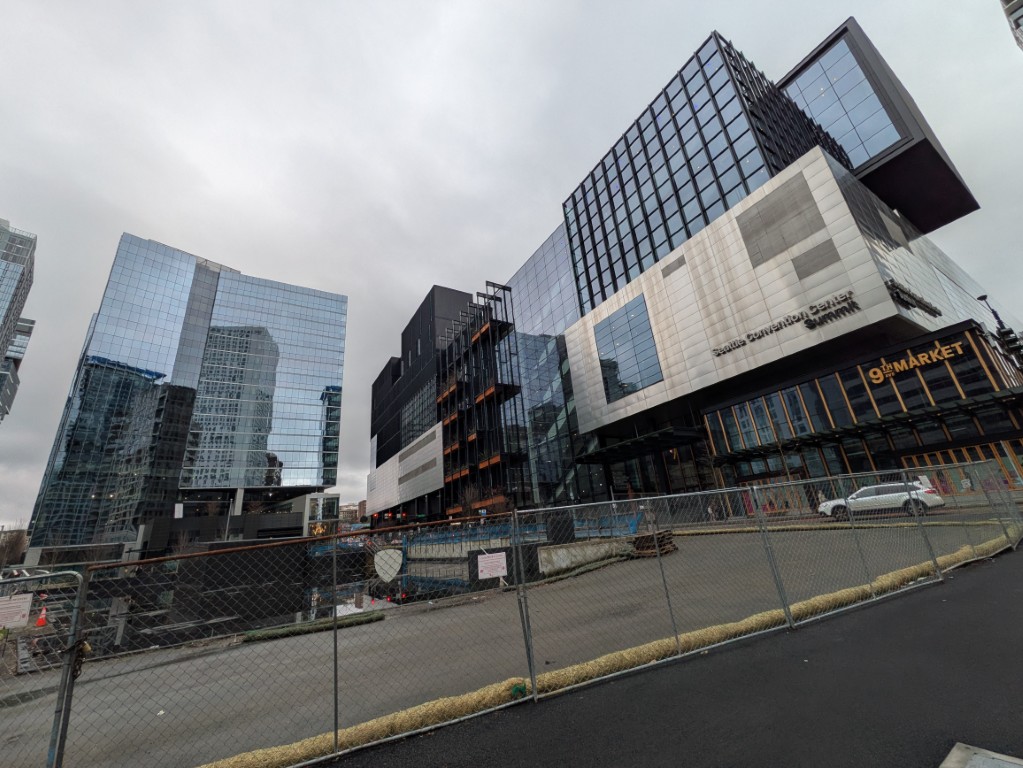 Washington 1000 (left, empty) and the Summit (right). In foreground, the fenced parcel at 920 Olive Way.