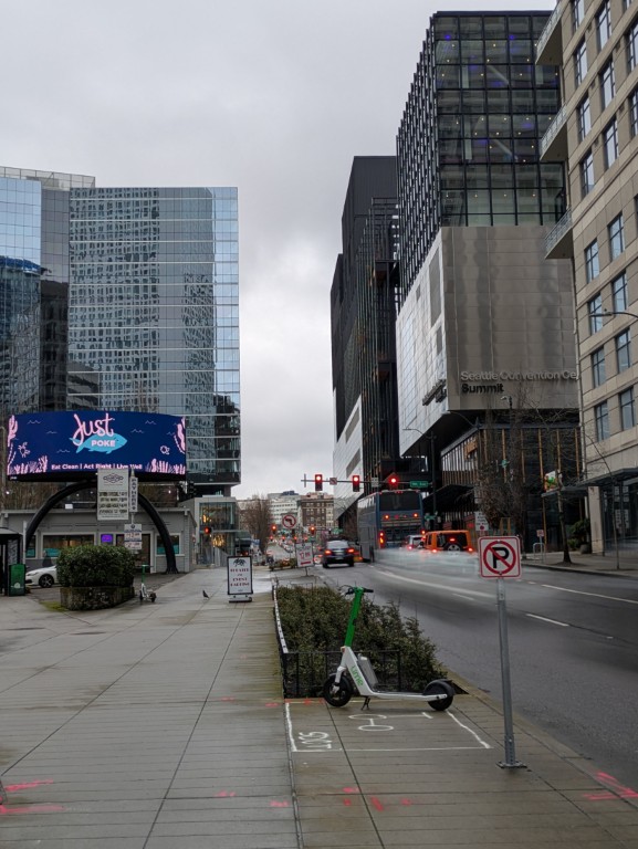 Olive Way looking up toward the Summit from downtown. Just Poké in foreground. The Summit (right). March 19, 2026.