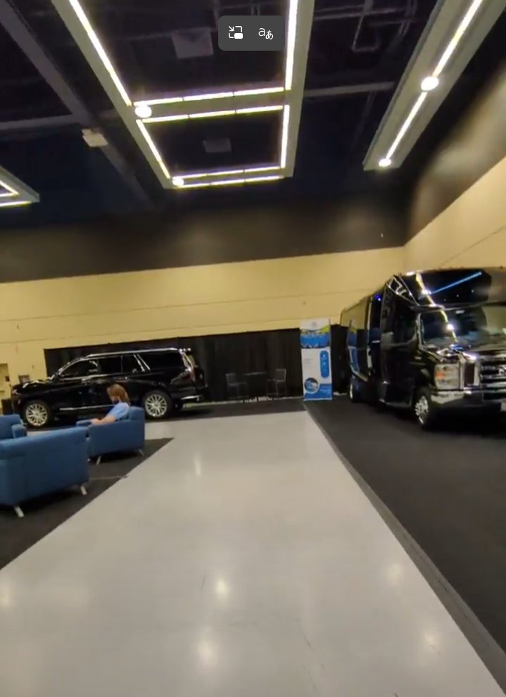 A convention center bus parked in the corner of a venue