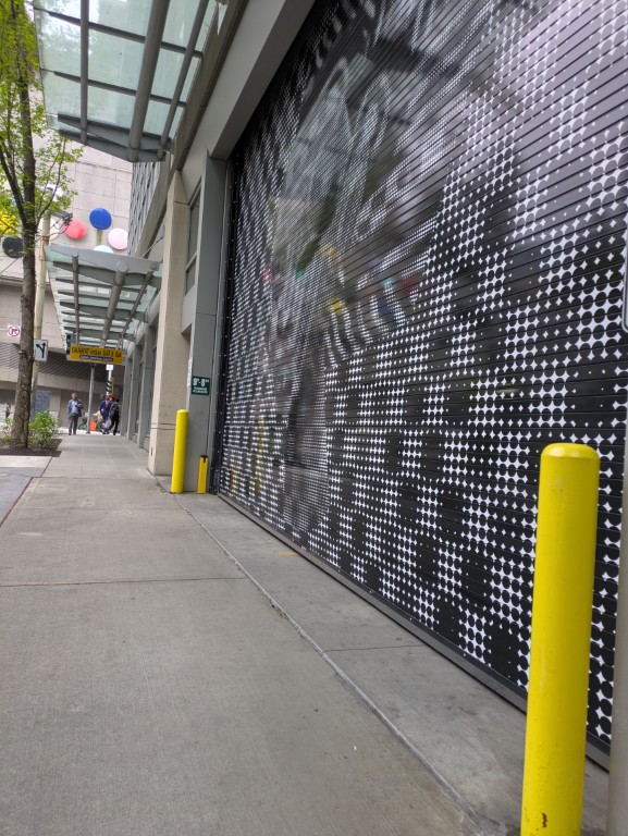 The service entrance on 9th Avenue between Pike and Pine — vehicle clearance 8 feet 8 inches, across from the Paramount Theater stage door. May 6, 2026.