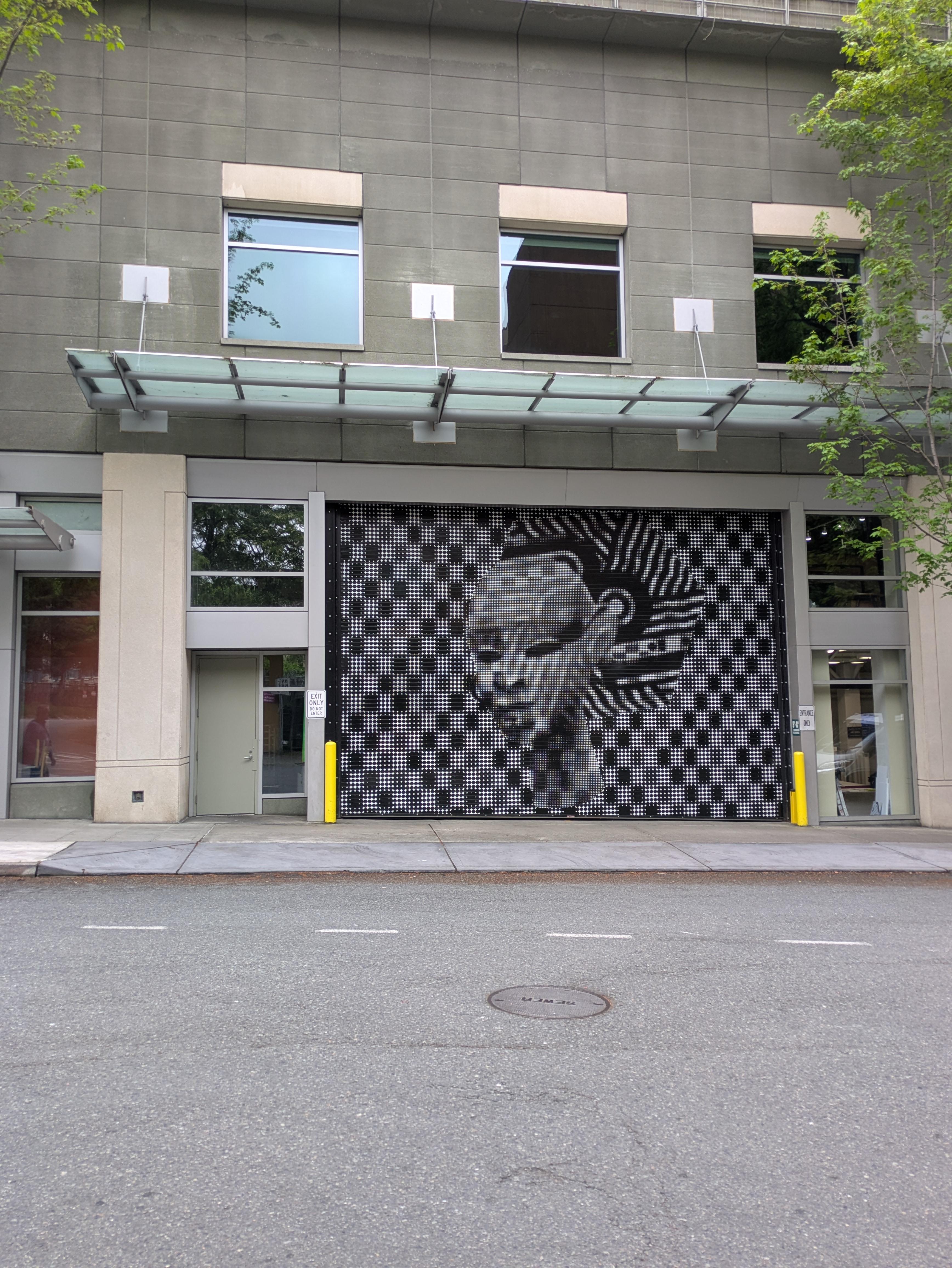 The service entrance on 9th Avenue between Pike and Pine — vehicle clearance 8 feet 8 inches, across from the Paramount Theater stage door. May 6, 2026.