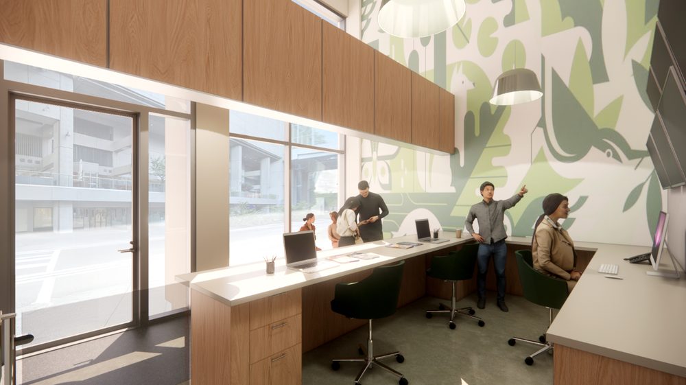 A warm, wood-toned open office with a large planted green wall and figures at standing counters with laptops.