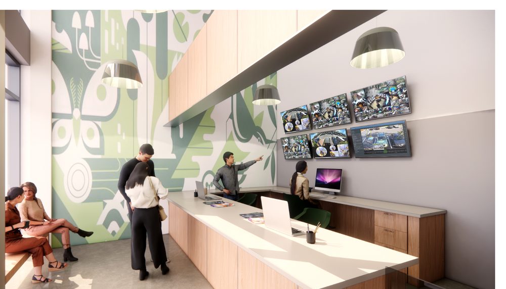 A reception desk beside a wall of roughly eight video monitors carrying multiple camera feeds.