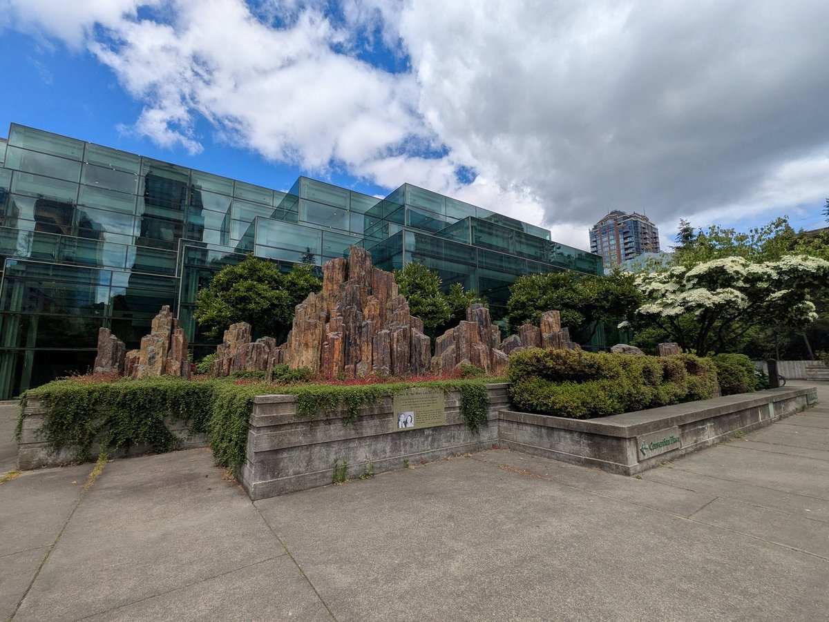 The James R. and Mary Lou Ellis Plaza and its basalt rockery against the convention center's glass wall