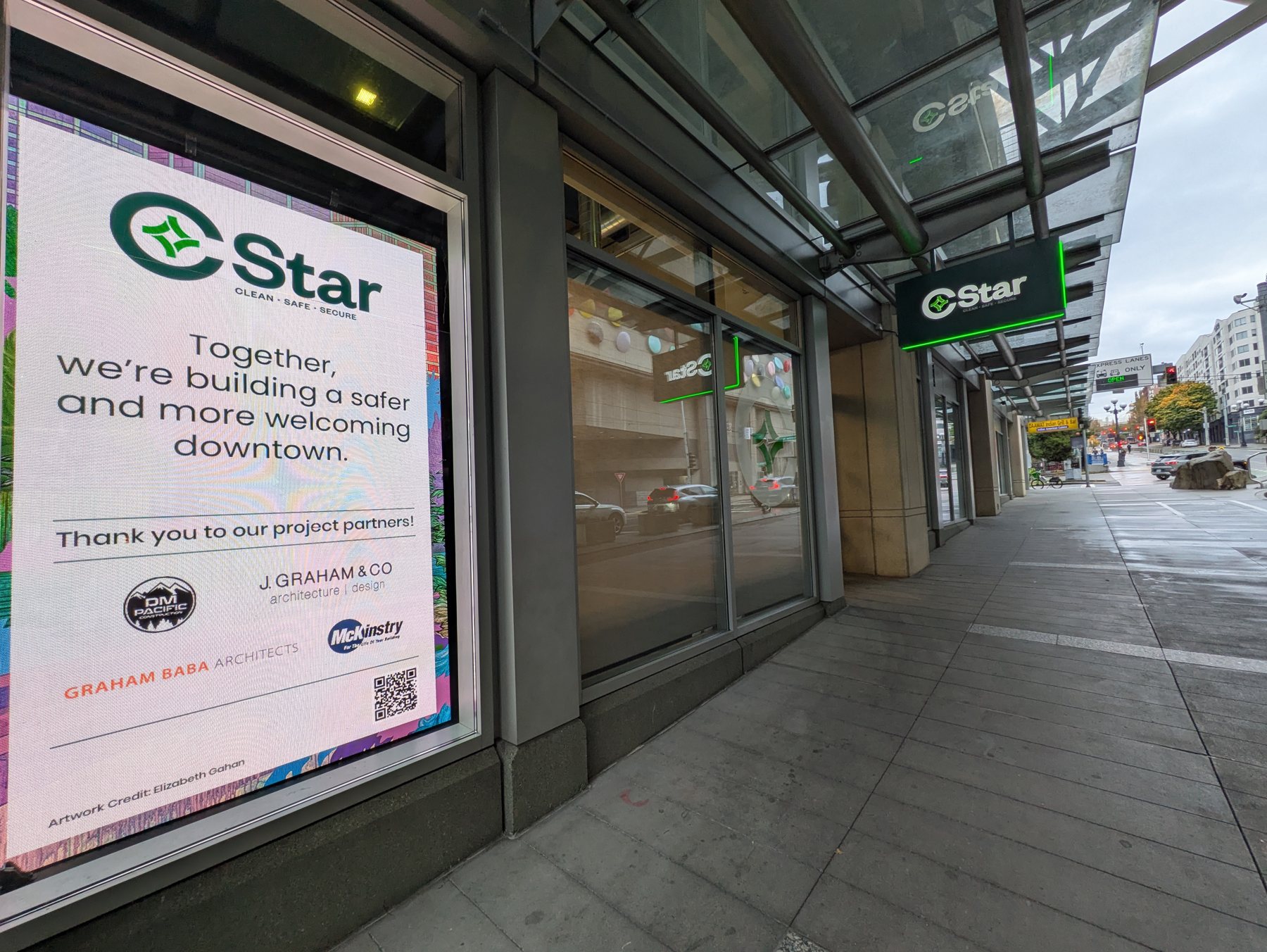 The digital signage in the window: "Together, we're building a safer and more welcoming downtown. Thank you to our project partners!" October 9, 2026. Photo: Ivan Schneider.